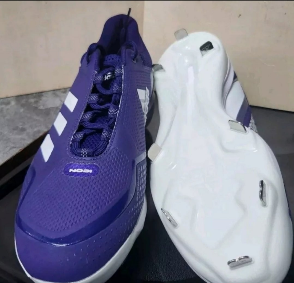 Purple Adidas Icon 7 metal cleats with a sleek design and durable traction for optimal performance