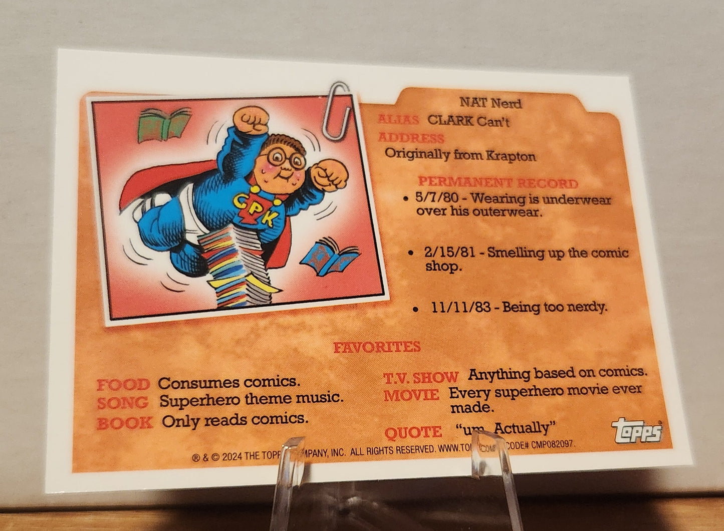 Banana Anna Garbage Pail Kids card featuring a nerd in superhero attire surrounded by comic books