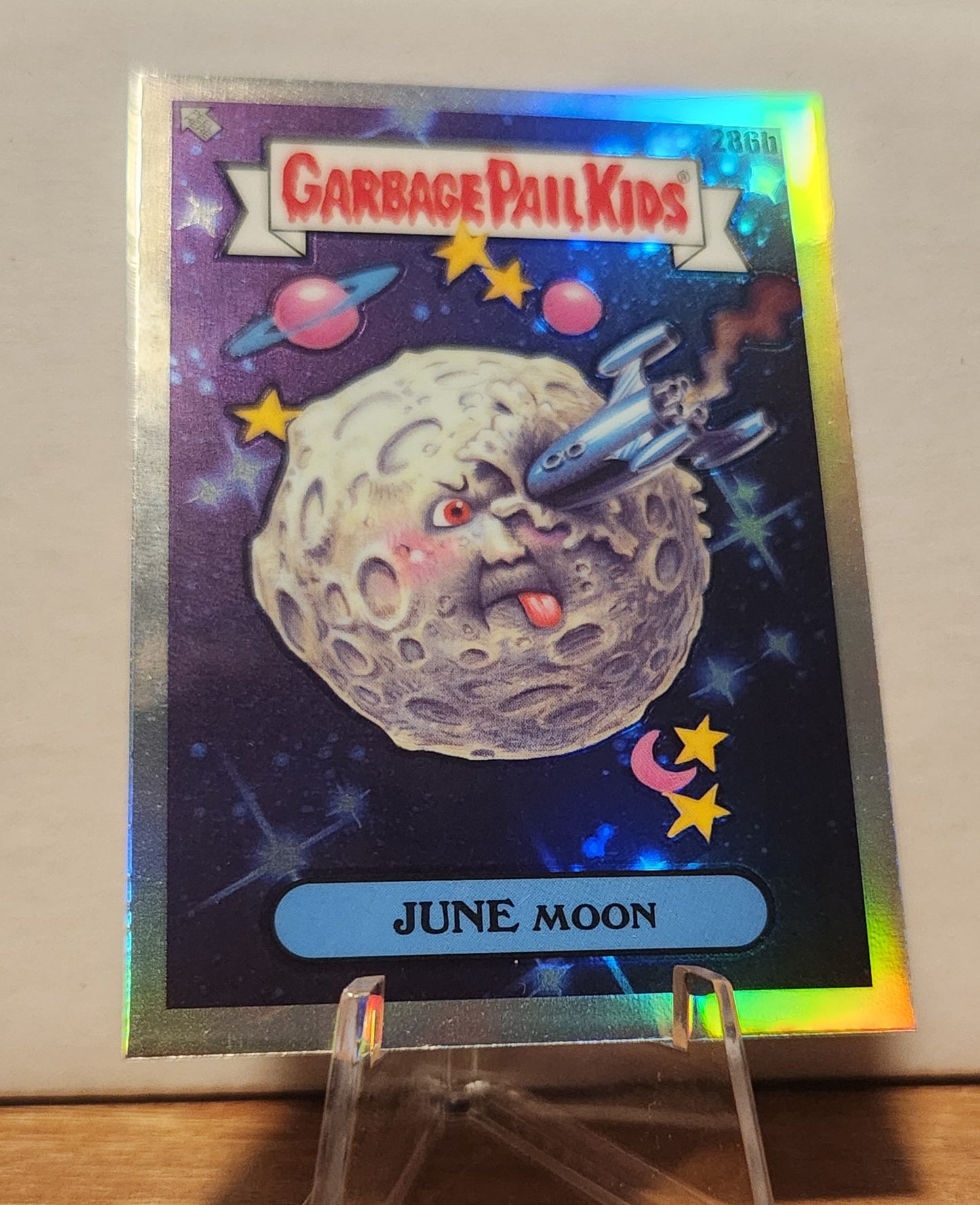 Garbage Pail Kids June Moon card featuring a whimsical moon character and colorful space background
