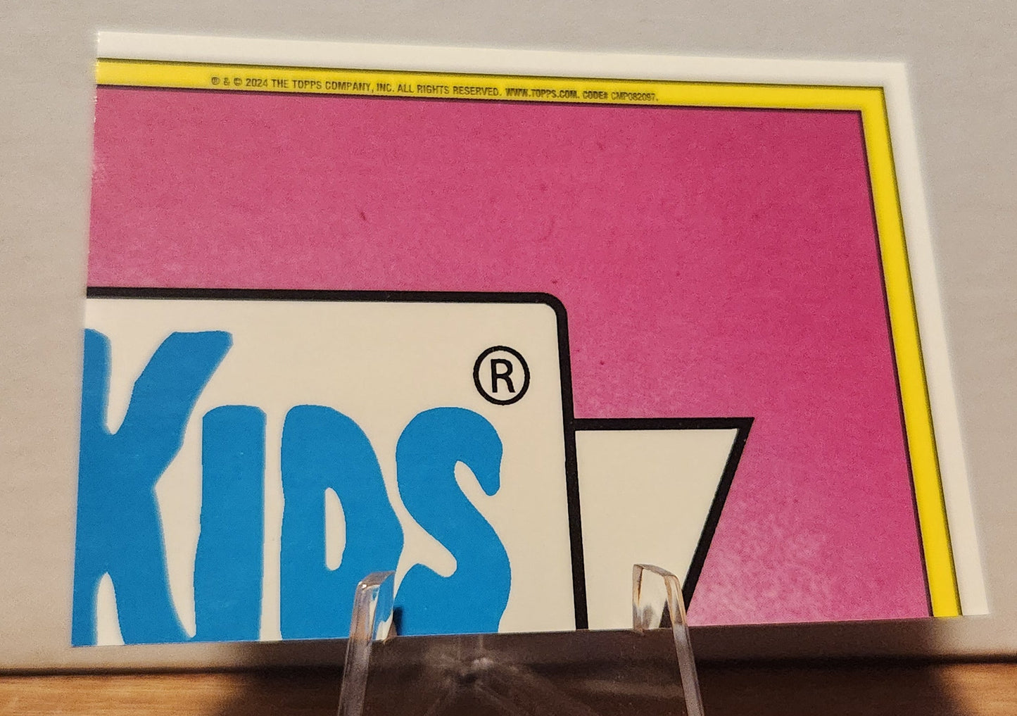 Back of Garbage Pail Kids Sandy Clod card featuring bright pink background and logo detail