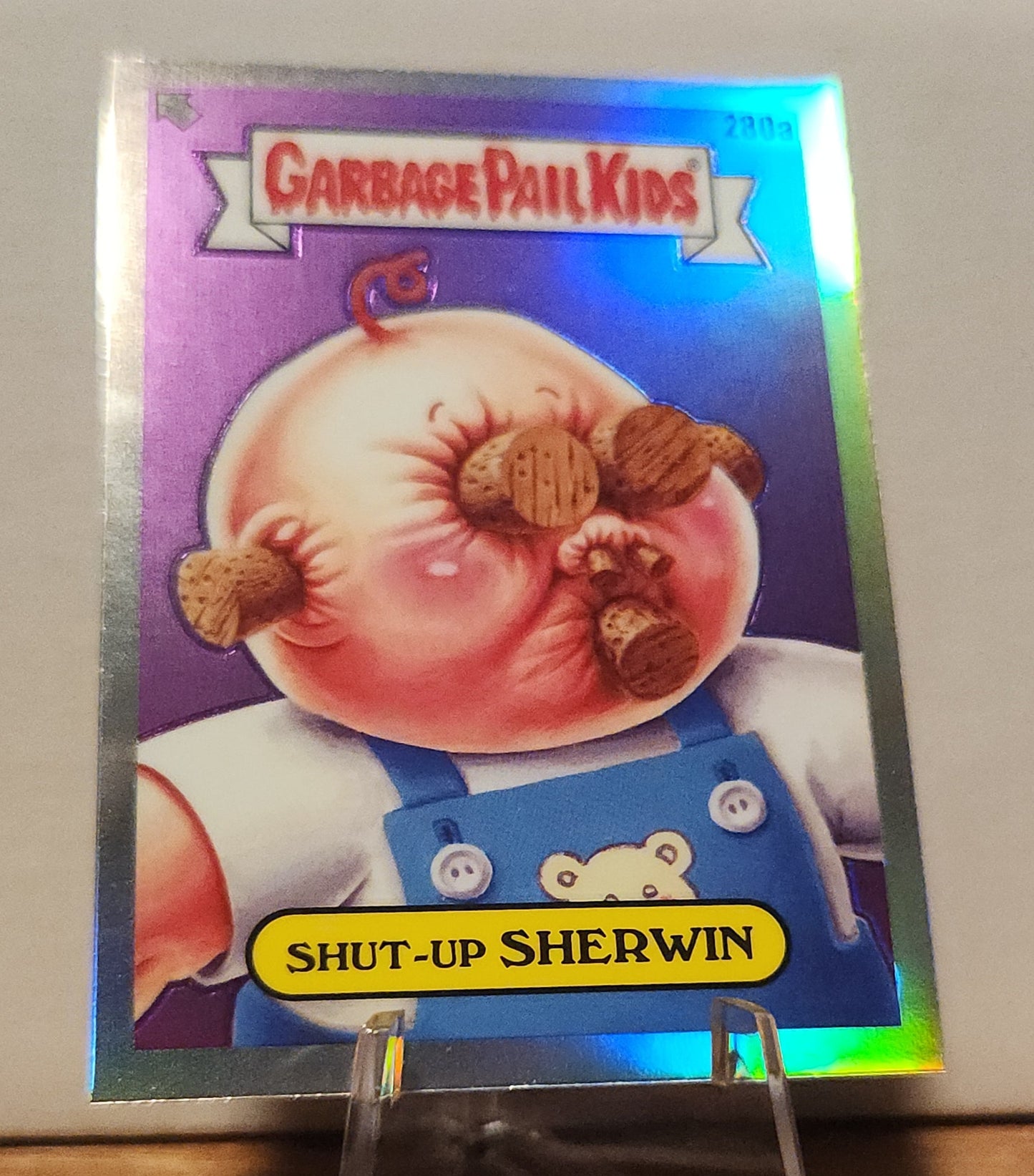 Garbage Pail Kids Shut-Up Sherwin card value with shiny holographic background and character detail