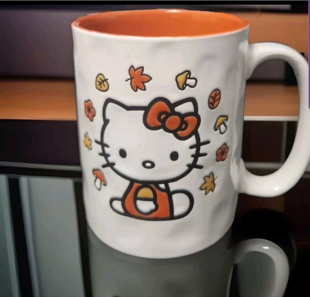 Hello Kitty Halloween mug featuring a playful design with autumn leaves and a pumpkin motif