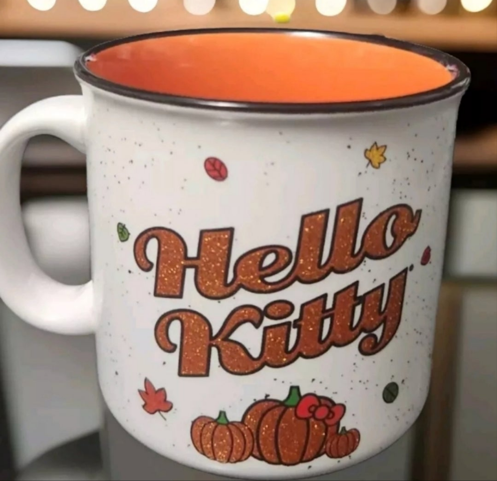 Hello Kitty pumpkin spice mug featuring colorful autumn leaves and pumpkins design