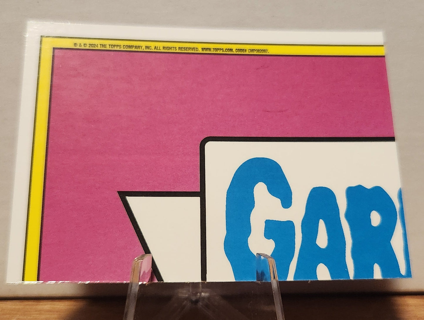 Magenta refractor Garbage Pail Kids card featuring vibrant colors and iconic design by Topps