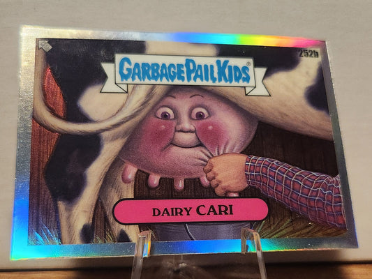 252B DAIRY CARI- GARBAGE PAIL KIDS-REFRACTOR card featuring a whimsical character with a cow background