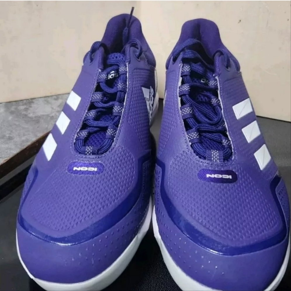 Adidas Icon 7 metal cleats in purple with white stripes designed for optimal performance in baseball