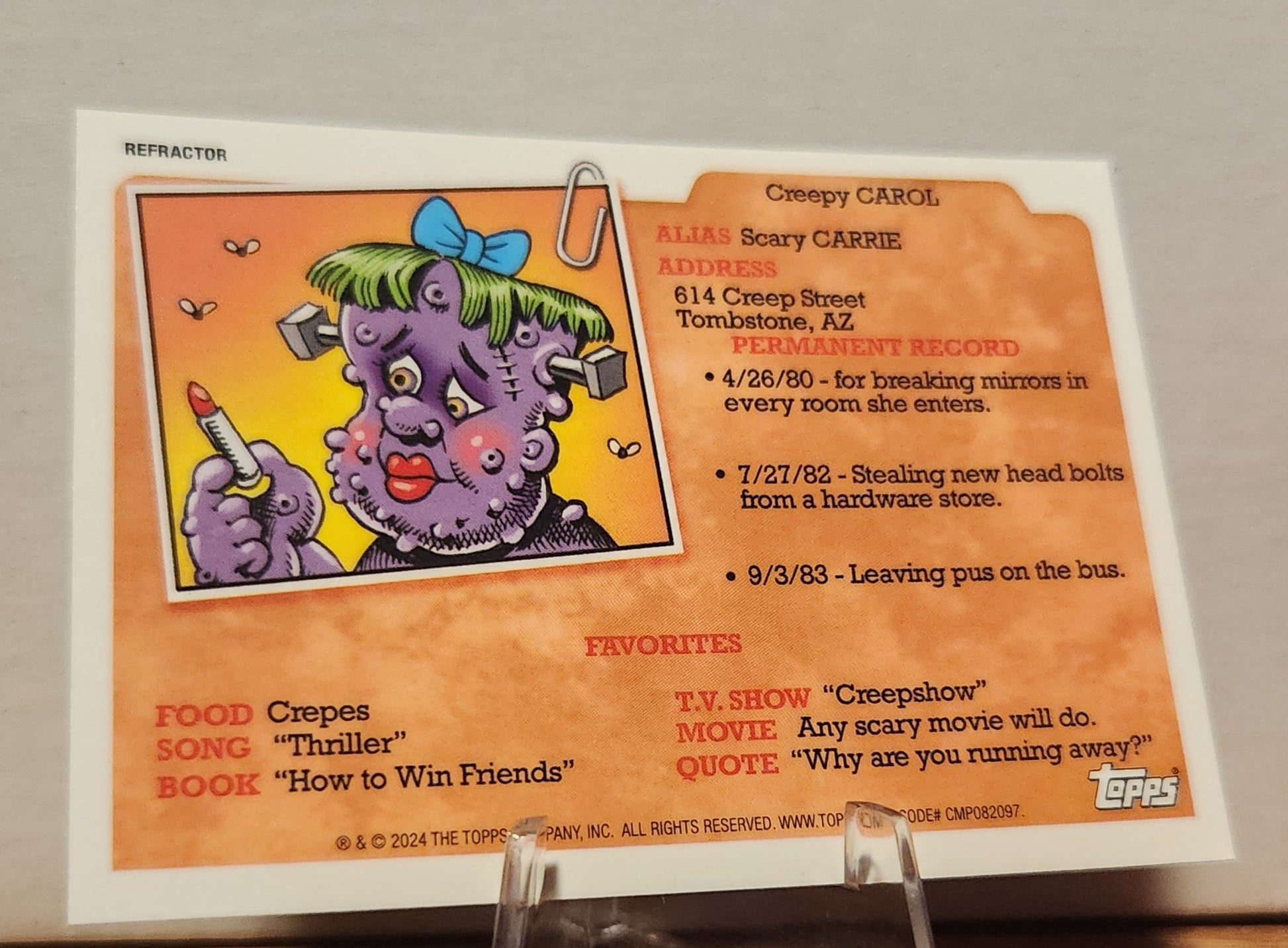 AN-2B KETTLE GRETEL- GARBAGE PAIL KIDS-REFRACTOR card featuring Creepy Carol with funny details and background