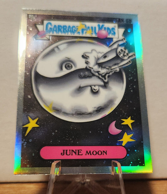 AN-6B JUNE MOON- GARBAGE PAIL KIDS-REFRACTOR collectible card featuring a quirky design and holographic effect