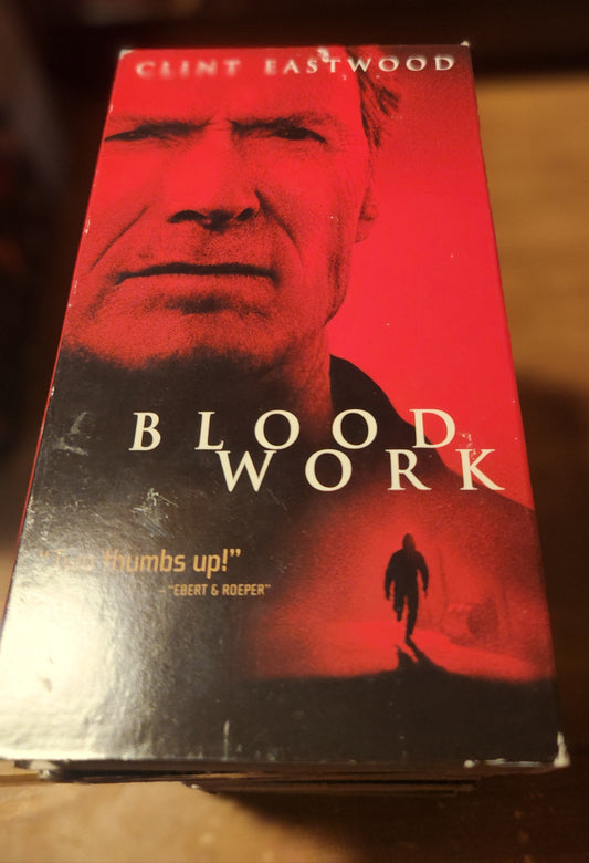Blood Work VHS collectible featuring Clint Eastwood in a red and black cover from Lawrence's Collectibles
