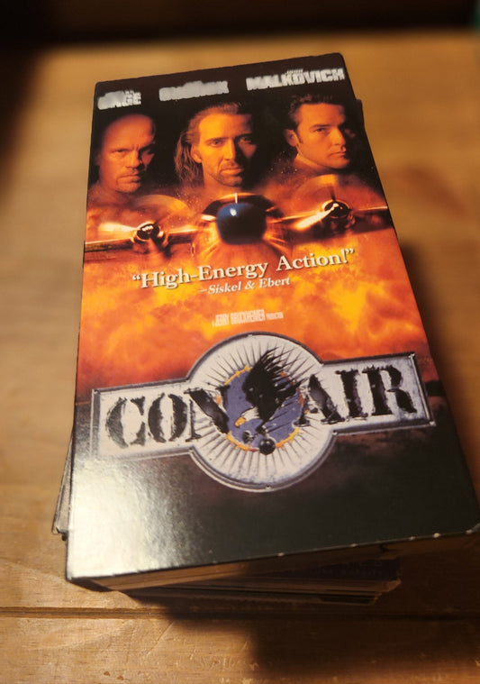 Conair VHS collectible tape featuring action movie cover with Nicolas Cage and John Malkovich