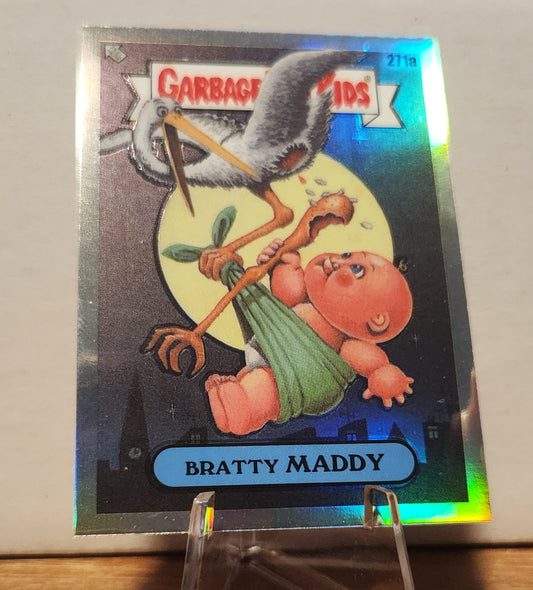 Garbage Pail Kids Bratty Maddy trading card featuring a baby and a stork against a night scene
