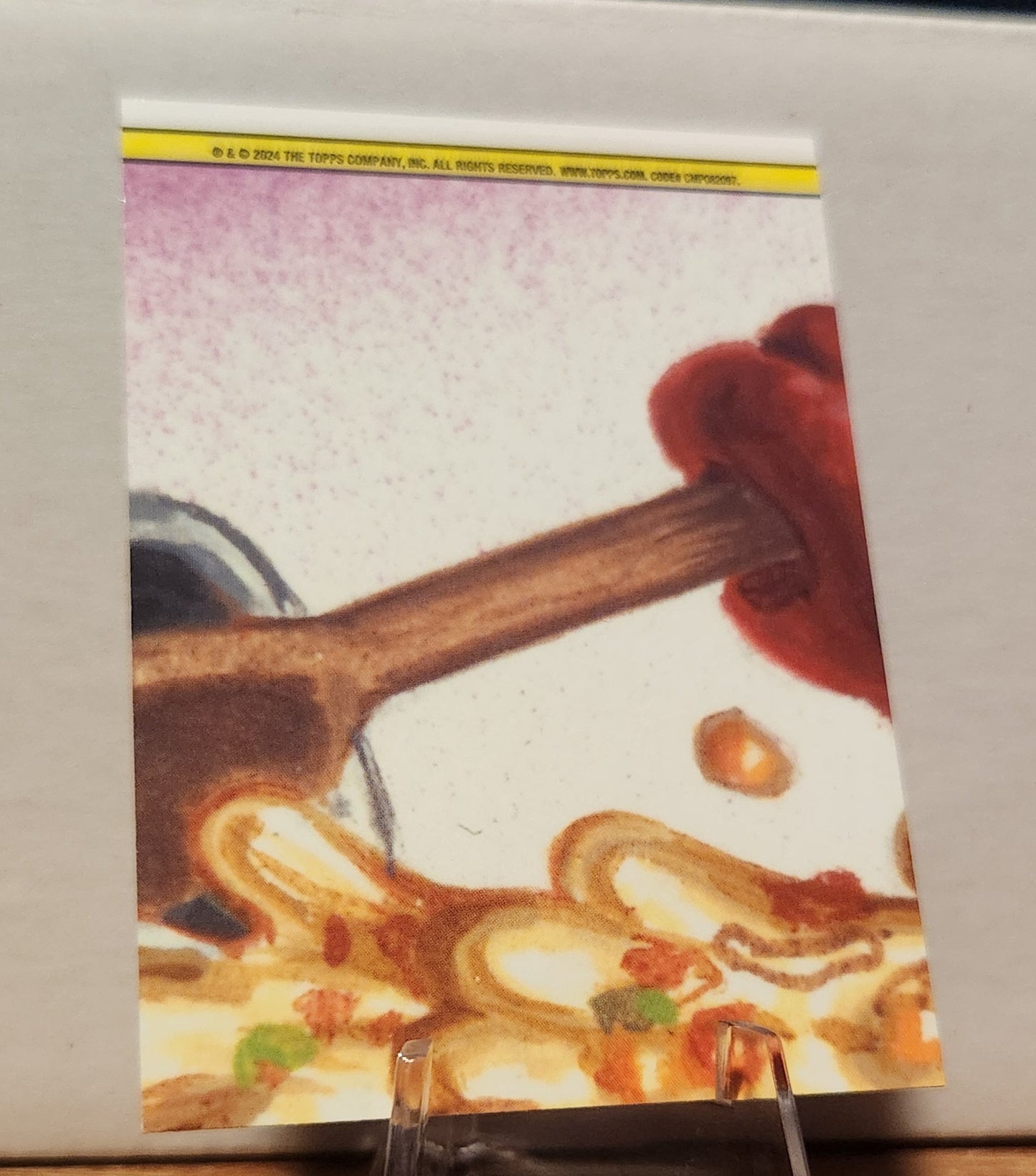 Bratty Maddy trading card featuring colorful artwork of a messy kitchen scene