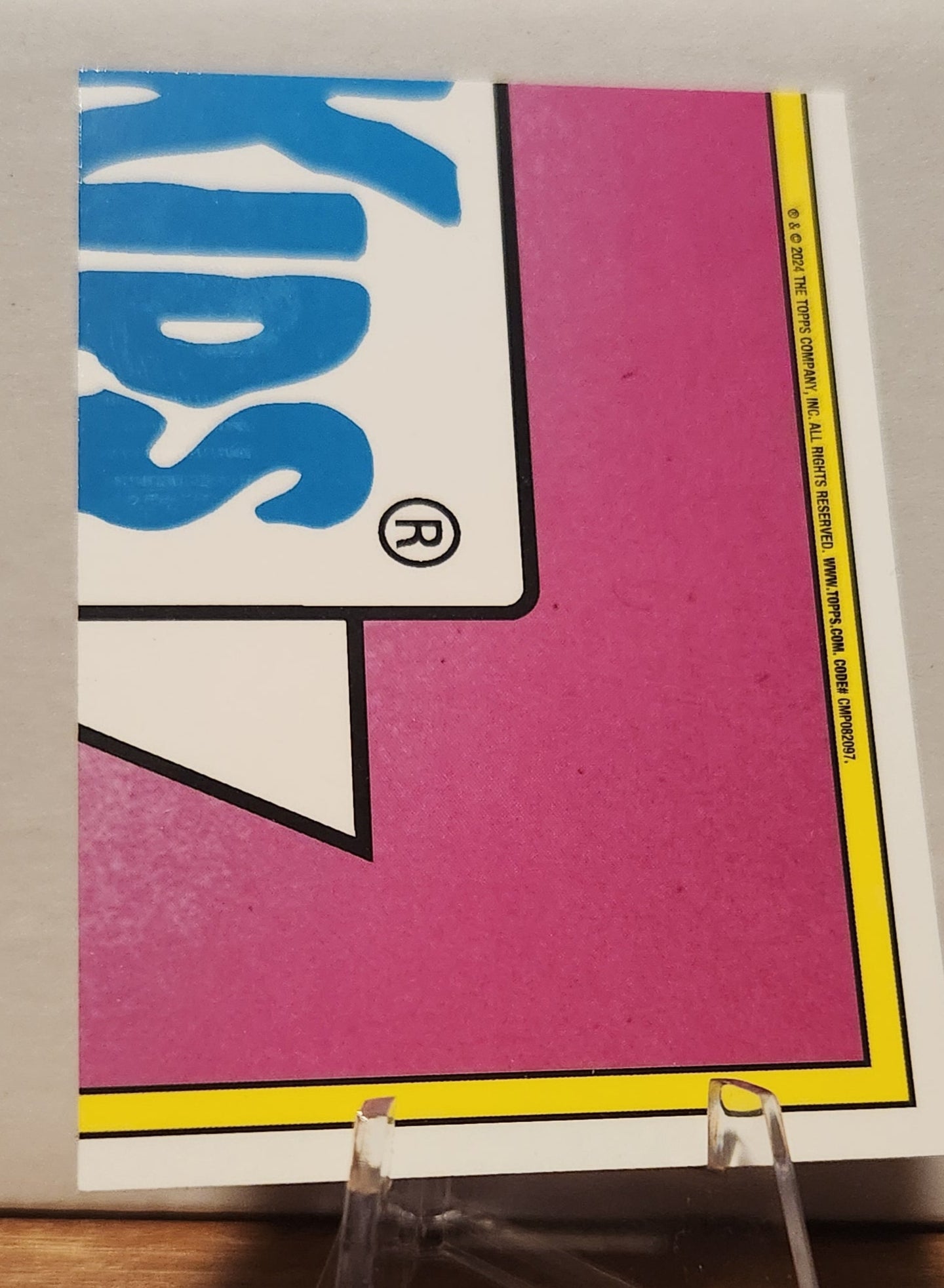 Back of the Garbage Pail Kids Chris Mess card featuring a vibrant pink design and classic logo