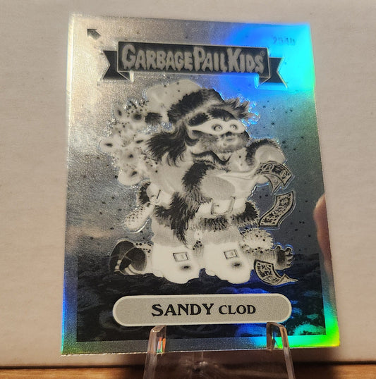 Garbage Pail Kids Sandy Clod card featuring a festive, holographic design with colorful details