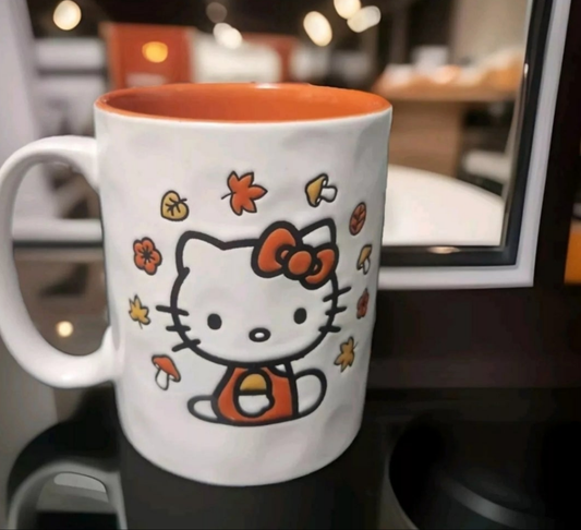Hello Kitty Halloween mug featuring a cute design with autumn leaves and a bow