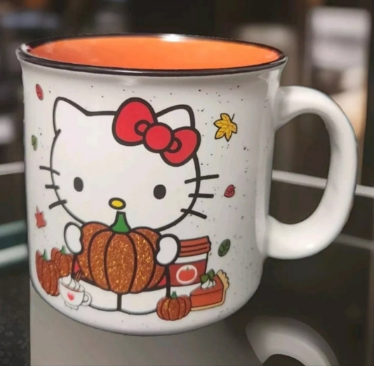 Cute Hello Kitty pumpkin spice mug featuring Hello Kitty holding a pumpkin with autumn decorations