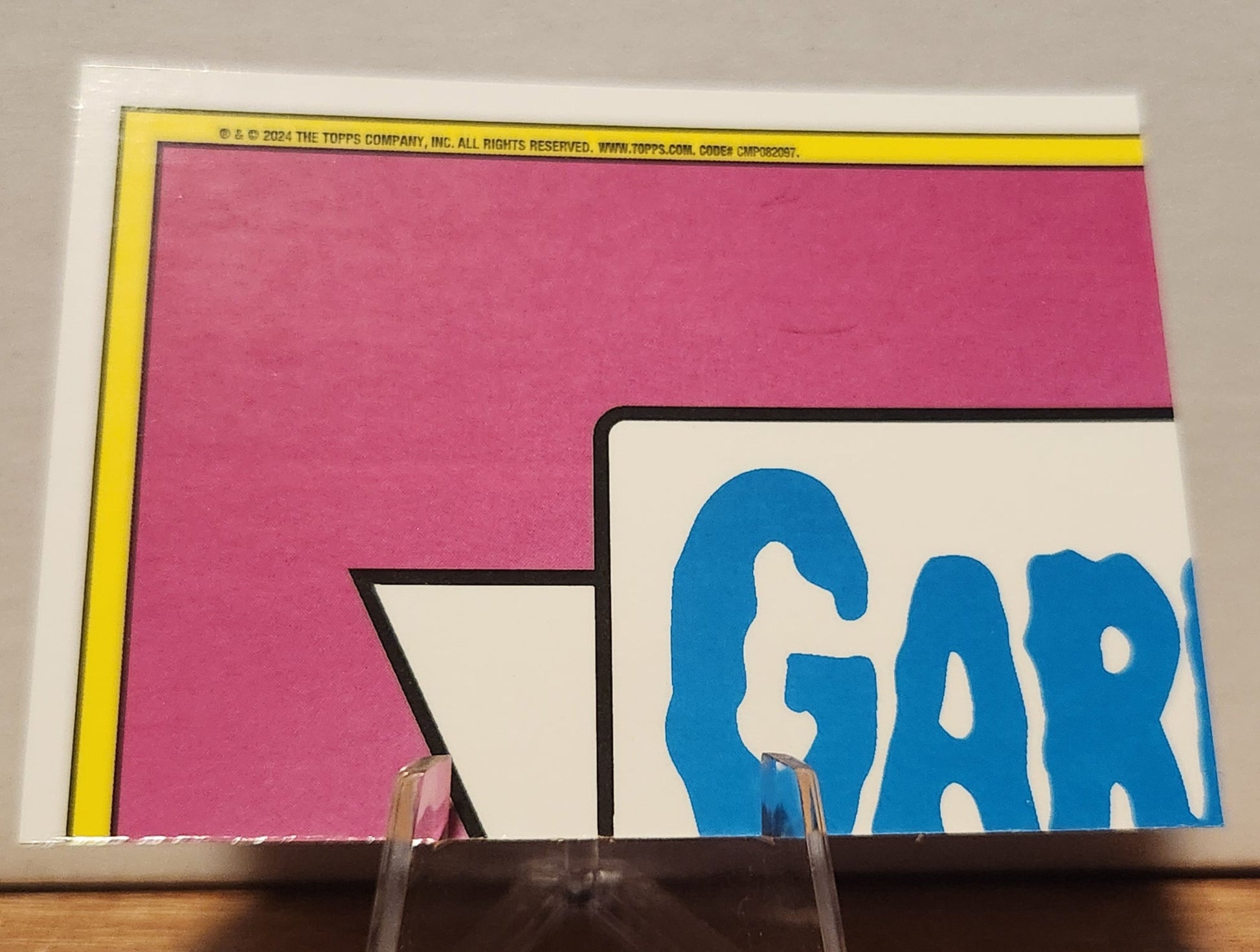 Magenta refractor Garbage Pail Kids card featuring vibrant colors and iconic design by Topps