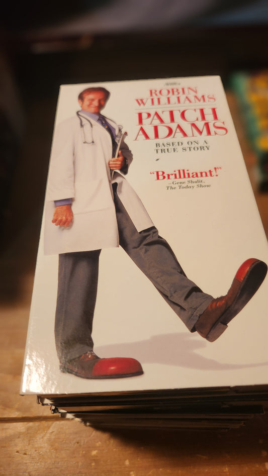 Lawrence's Collectibles Patch Adams VHS tape featuring Robin Williams in a white coat and clown shoes