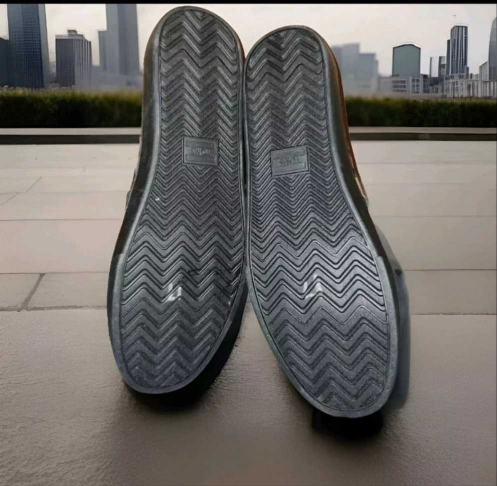 Bottom view of TOMS Dia De Los Muertos shoes showcasing the unique tread pattern and design details