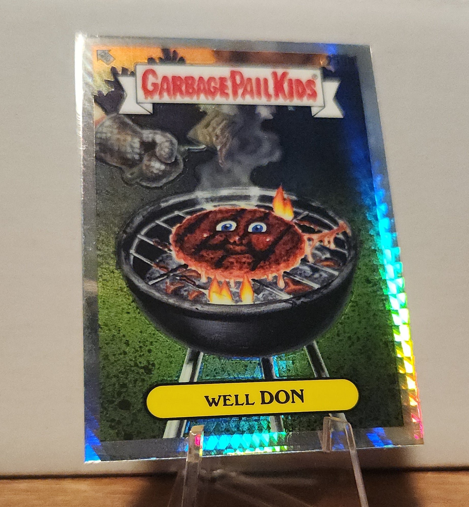 Well Done trading card- TOPPS GARBAGE PAIL KIDS featuring a humorous cartoon burger on a grill