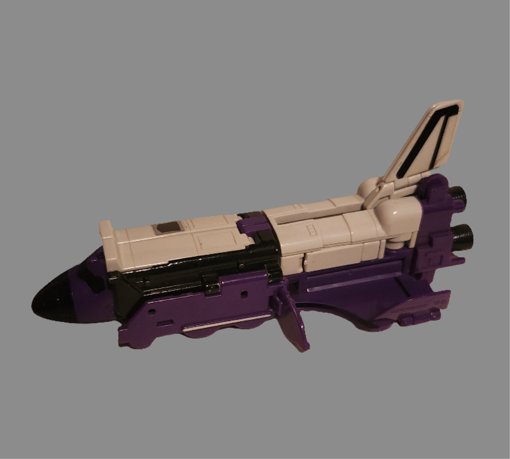 Astrotrain Transformer collectible in shuttle mode with purple and white design