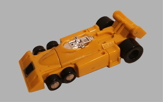 Drag Strip Transformers collectible in yellow, a vintage toy car with detailed features and wheels