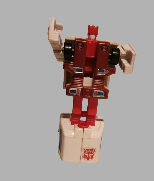 Transformers Protectobots First Aid toy in red and white with movable arms and classic Autobot emblem