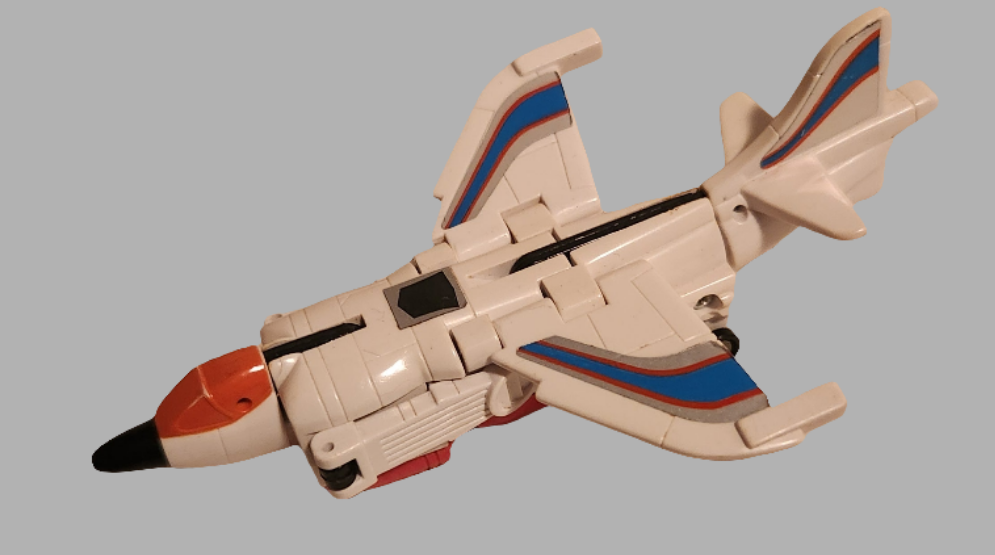 Transformers Slingshot collectible in white and orange design, resembling a jet with detailed features