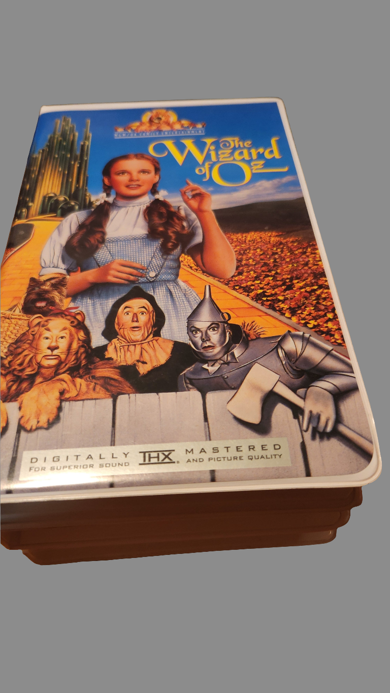 The Wizard of Oz collectibles featuring a classic VHS cover with iconic characters and vibrant graphics